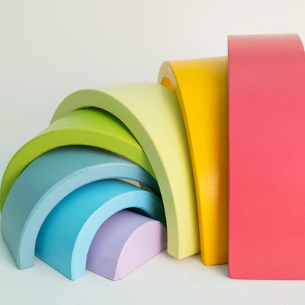 Set of colorful wooden arches on a light gray background
